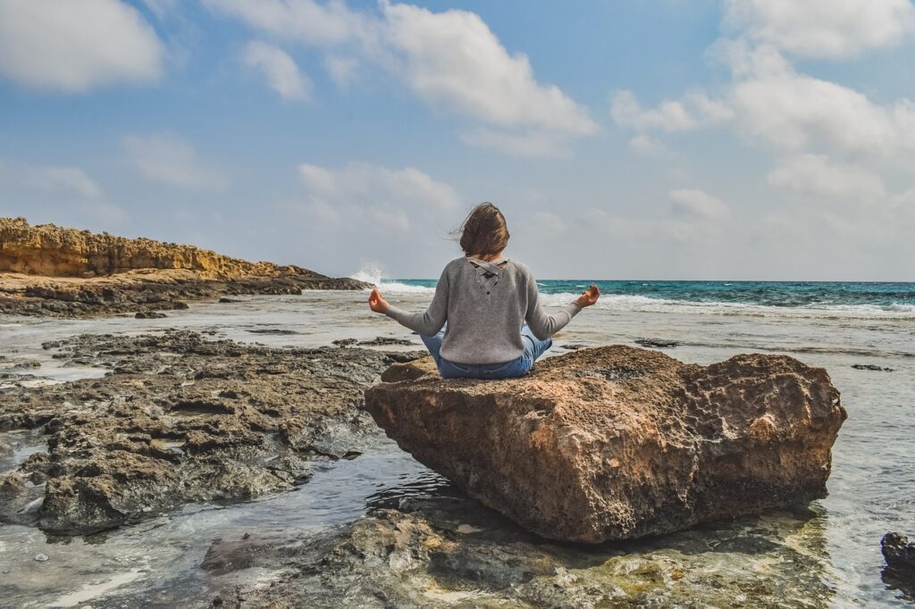 hedonic vs. eudaimonic happiness - mindful woman on a beach